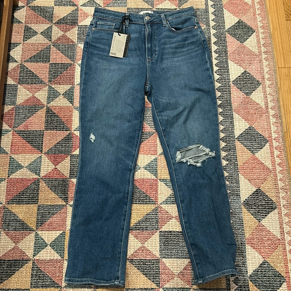 Medium blue wash, ripped knee, soft denim with stretch, straight leg.